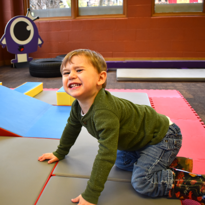 Little boy smiling on mini monster course