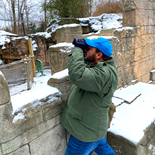 Man looking through binoculaurs