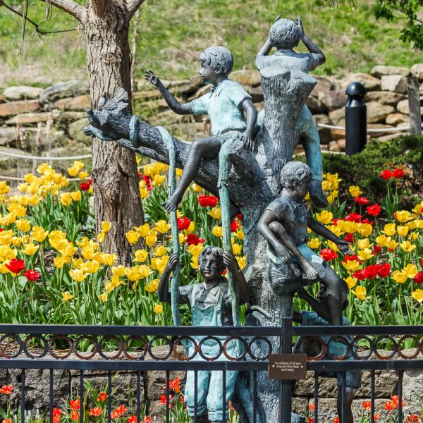 Flowers behind a sculpture